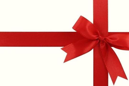 Red ribbon tied in a bow on a white background, crossing horizontally and vertically.